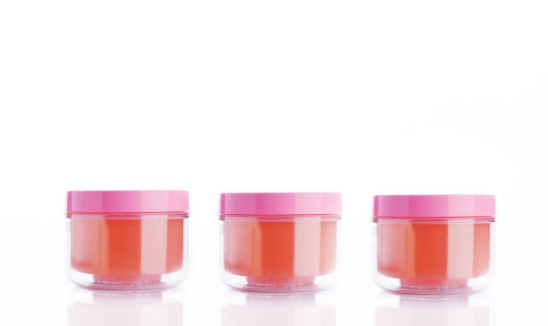 green and red plastic containers for cosmetic products, isolated on white
