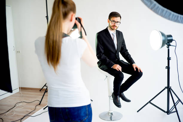 istock Photographer taking picture of a model in studio 698785808