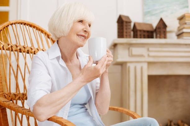 istock Lively bright lady drinking coffee at home 698790962