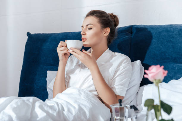 istock Young woman having morning coffee in bed 698791558