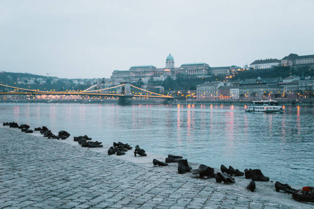 Budapest, Hungary- February 22, 2015: The shoe memorial in Budapest, Hungary, which honors the Jewish people who got killed by fascist troops in the hungarian capital during World War II. The shoes represent the fact they got the order to take off their shoes before being killed and thrown to the Danube river.
