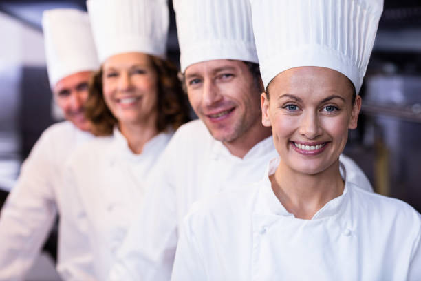 istock Happy chefs team standing together in commercial kitchen 698802852
