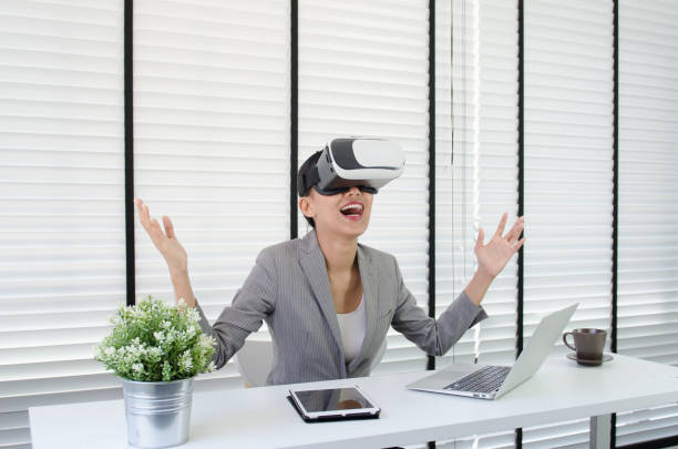 istock Asian woman use virtual reality glasses ( VR ) in her office 698807892