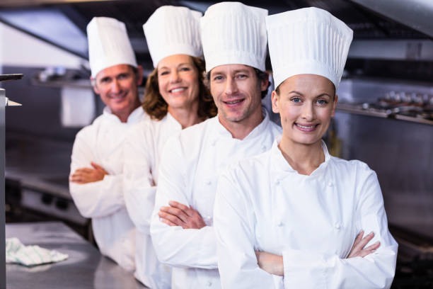 istock Happy chefs team standing together in commercial kitchen 698807932