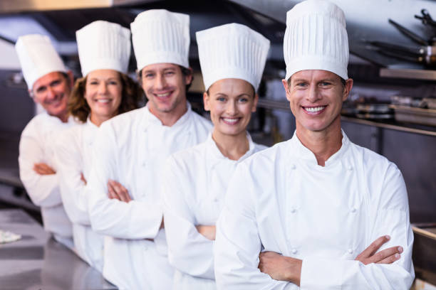 istock Happy chefs team standing together in commercial kitchen 698808336