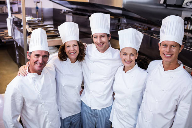 istock Happy chefs team standing together in commercial kitchen 698808410