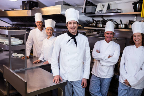 istock Happy chefs team standing together in commercial kitchen 698808922