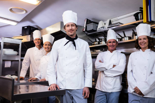 istock Happy chefs team standing together in commercial kitchen 698809036