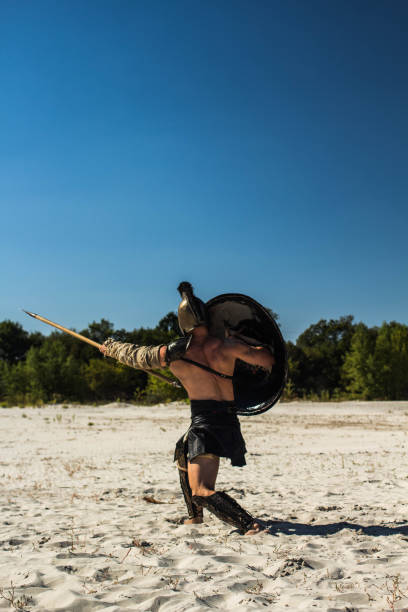 istock View from the back to the Spartan with a shield on the trampled field 698820182