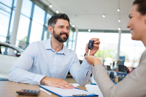 istock Agent Giving Car Key To Woman 698827140