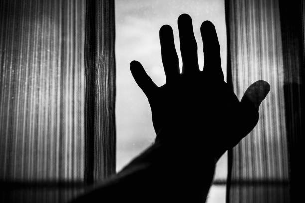 istock Male hand silhuette and tulle on window 698841752