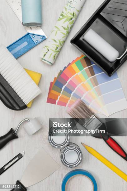Painting Tools Paint Swatches And Wall Paper Roll Overhead Stock Photo - Download Image Now