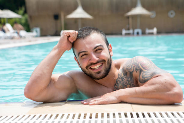 istock Young man at swiming pool 698844910