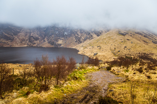 A beautiful irish mountain landscape with a lake in spring. Gleninchaquin park in Ireland.