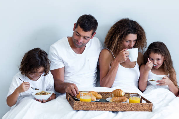istock Family having breakfast in bed 698848654