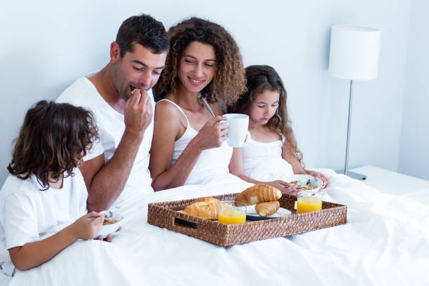 istock Family having breakfast in bed 698850148