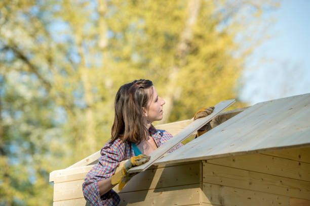 istock Young woman bulding garden hut 698852260