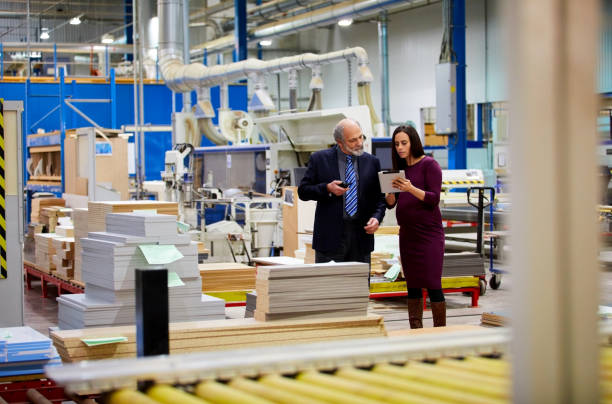 istock Business people on factory shopfloor using digital tablet 698864072