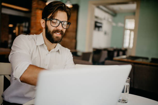 istock Man with glasses is checking emails on the laptop 698864994