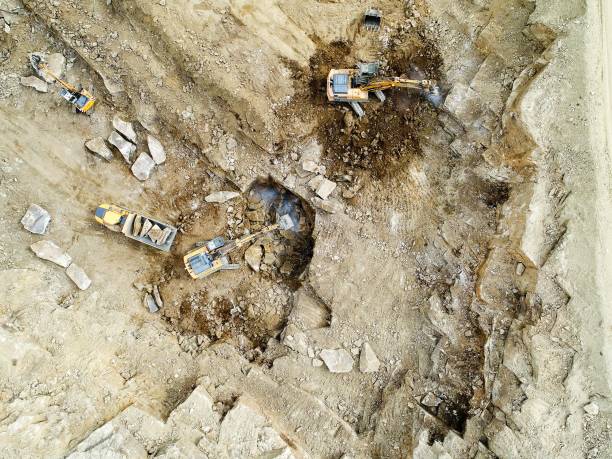 istock Aerial view of quarry pit with machines working 698870060