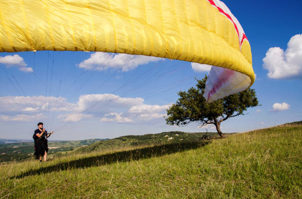 istock Man raising parglider in the air 698885158