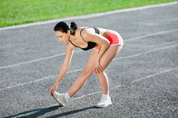 istock Full body of girl warming up before running 698891428