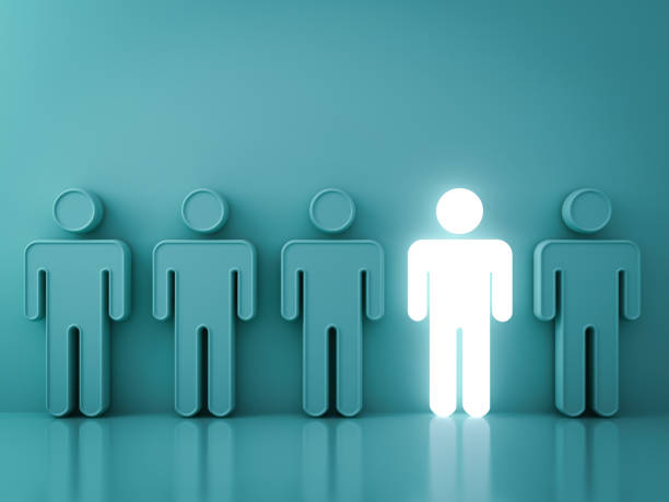 Stand out from the crowd and different creative idea concepts , One glowing light man standing among green people on green background with reflections and shadows . 3D render
