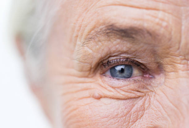 close up of senior woman face and eye age, vision and old people concept - close up of senior woman face and eye eye closeup stock pictures, royalty-free photos & images
