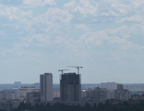 istock Building crane and building under construction against blue sky 698896492