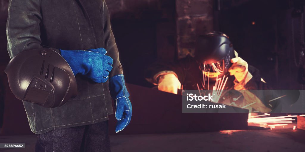 Welder in the factory Welder in the workshop at the factory Welder Stock Photo