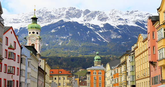 Old town buildings of Innsbruck, cityscape panorama and Idyllic North Tyrol snowcapped Karwendel mountain range at sunrise,  Austria