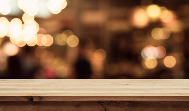 istock Wood table with blur light in night cafe,restaurant background 698904494