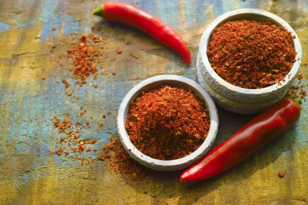 istock Red hot chili Cayenne pepper fresh and dried powdered spice, ready to use. 698911496