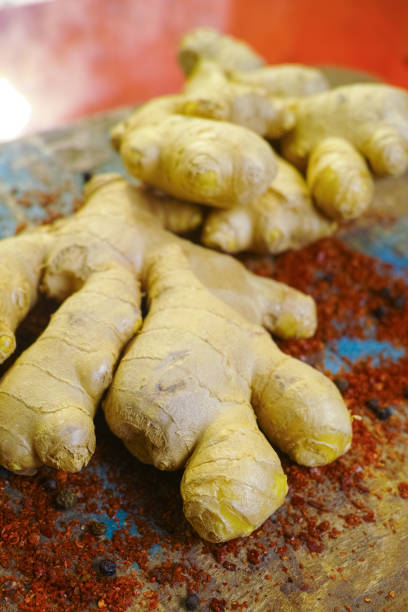istock Fresh organic ginger root with powdered Cayenne pepper on the wooden table 698911548