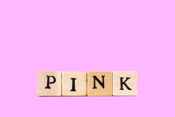 istock PINK: Written in Wood Block Letters, Pink Background 698911798