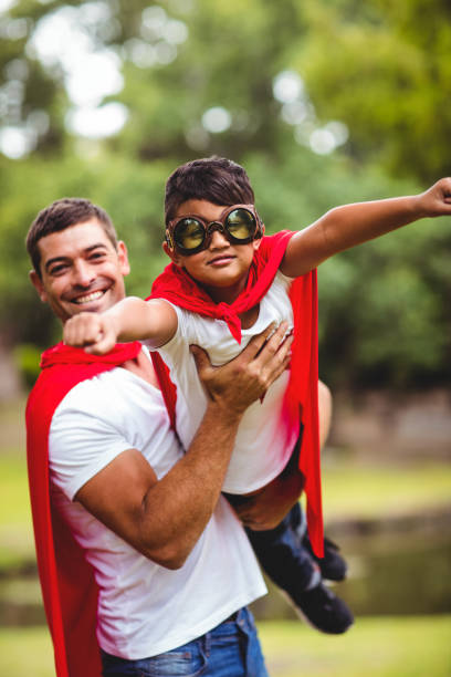 istock Father and son pretending to be superhero 698927914