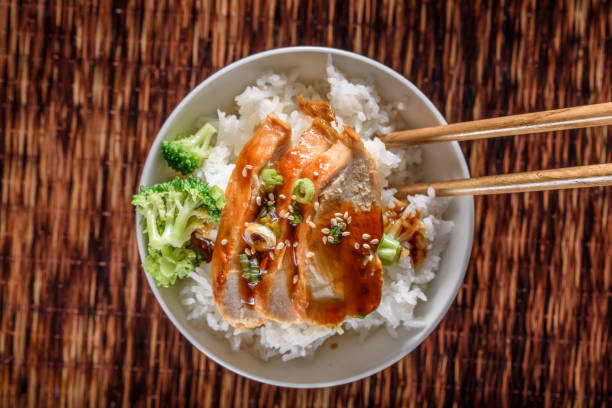 istock Grilled Chicken Breast with Teriyaki Sauce over Steamed Rice 698938736