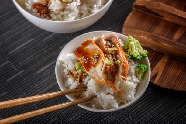 istock Grilled Chicken Breast with Teriyaki Sauce over Steamed Rice 698940914