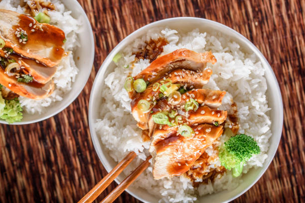 istock Grilled Chicken Breast with Teriyaki Sauce over Steamed Rice 698940920