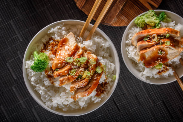 istock Grilled Chicken Breast with Teriyaki Sauce over Steamed Rice 698940922