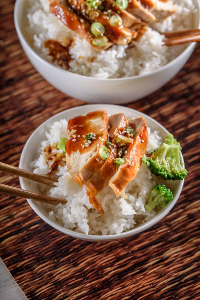istock Grilled Chicken Breast with Teriyaki Sauce over Steamed Rice 698943076