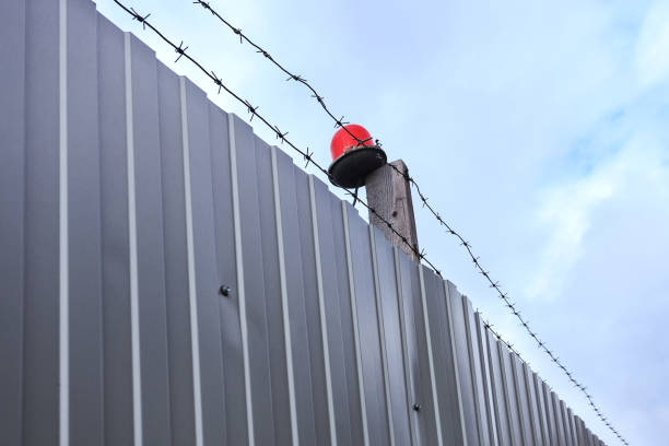 istock Barbed wire against the blue sky. 698943132