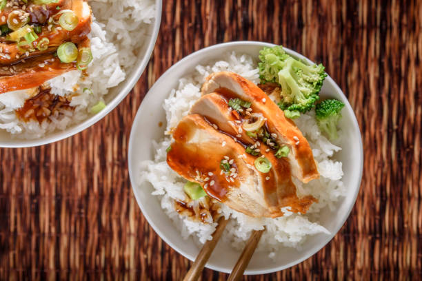 istock Grilled Chicken Breast with Teriyaki Sauce over Steamed Rice 698943282