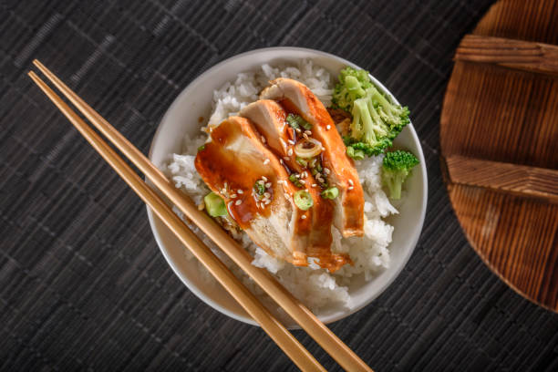 istock Grilled Chicken Breast with Teriyaki Sauce over Steamed Rice 698943348