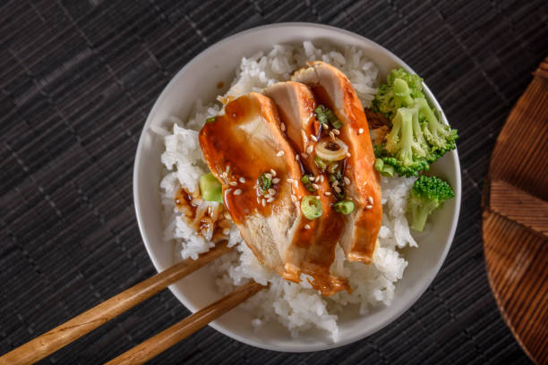 istock Grilled Chicken Breast with Teriyaki Sauce over Steamed Rice 698943392