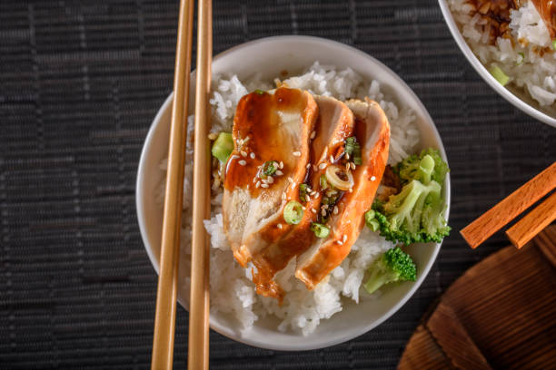 istock Grilled Chicken Breast with Teriyaki Sauce over Steamed Rice 698943428