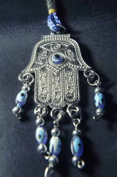 istock Blue Hamsa Hand isolated on a black background 698950732