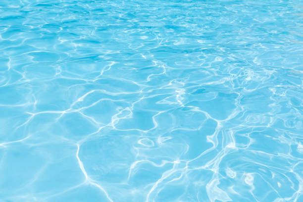 istock Blue water surface in swimming pool for background 698953854