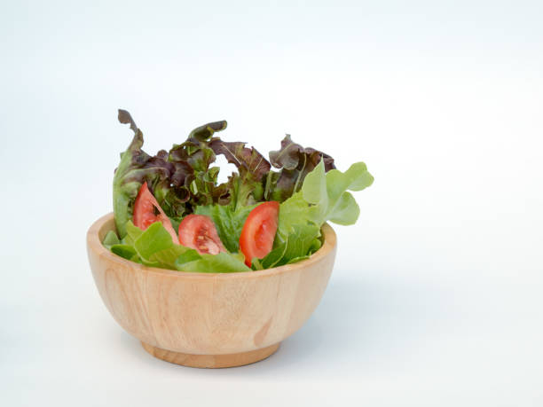 istock Wooden cup of salad on white background 698954128