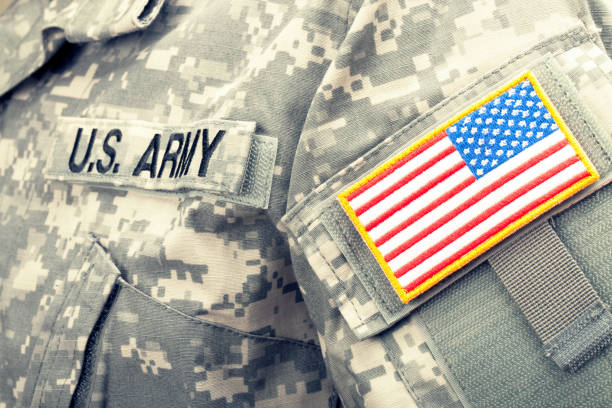 istock Studio shot of US flag shoulder patch on solder's uniform. Filtered image: cross processed vintage effect. 698954778